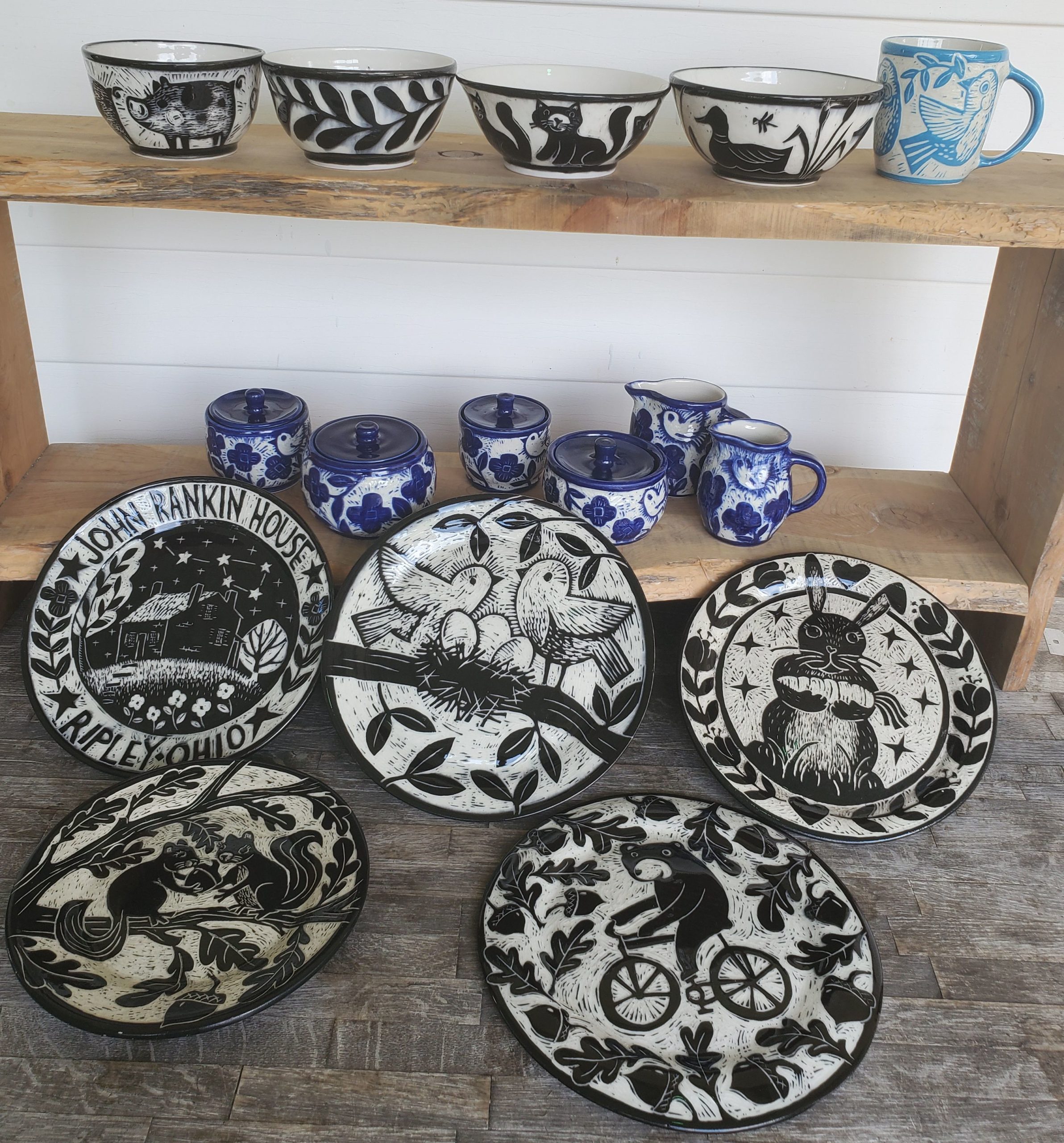 shelf on porch with beautiful handmade pottery