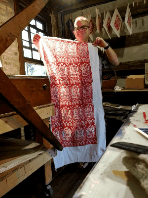 animation of artist holding hand printed fabric