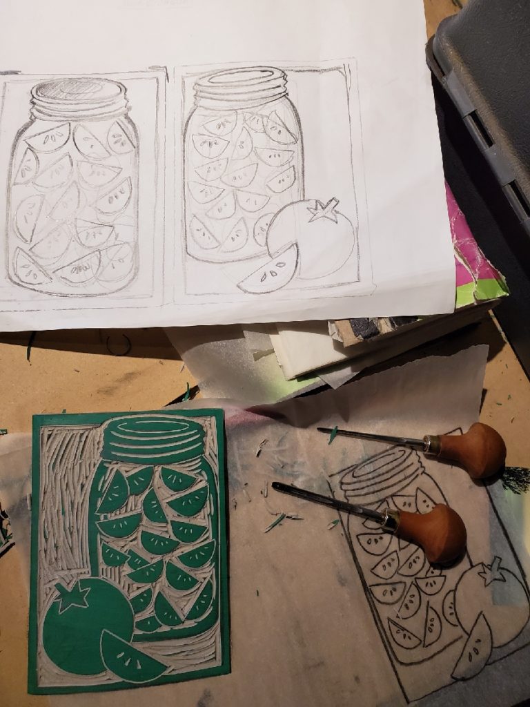 work in progress of a linocut depicting canned tomatoes