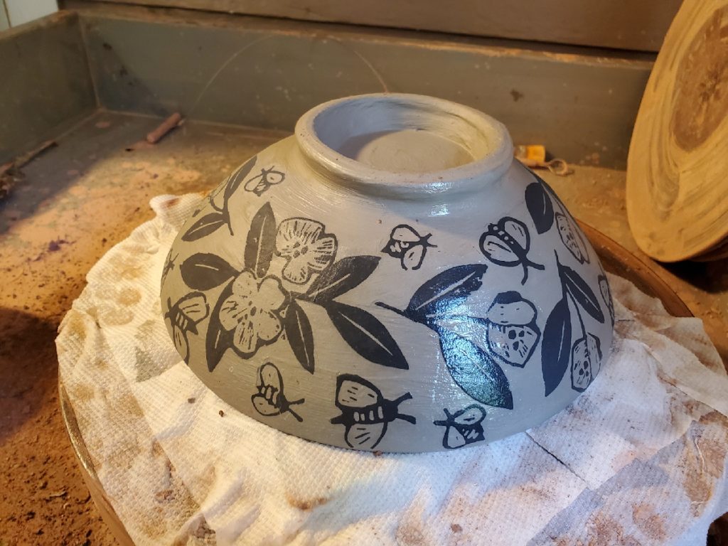 redware bowl with white slip and decals