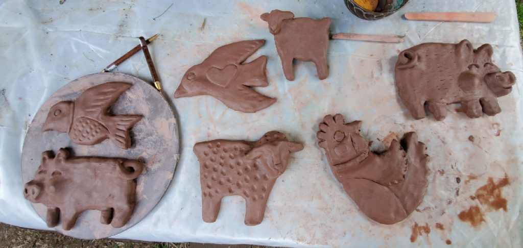 collection of clay animals pigs chicken birds sheep