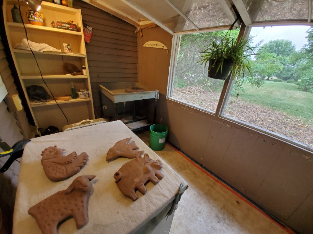 clay studio with clay sculptures drying