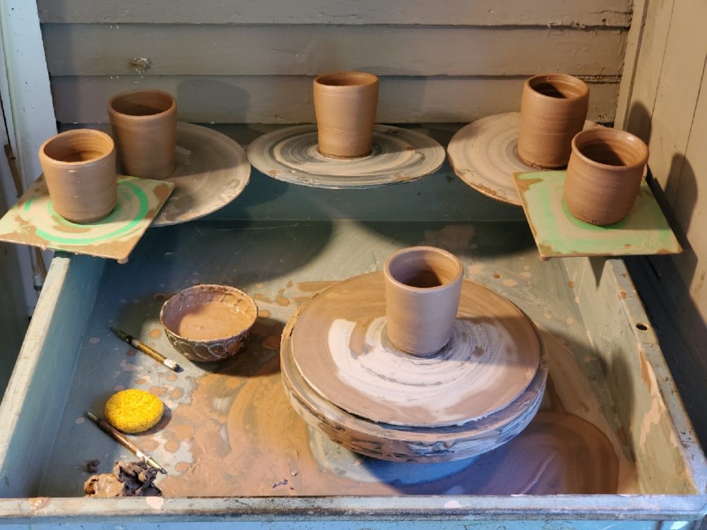 potters wheel with newly thrown pots around it