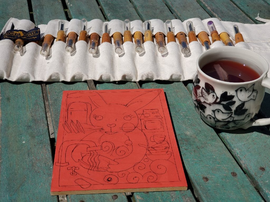 woodblock on table with knives and cup of tea