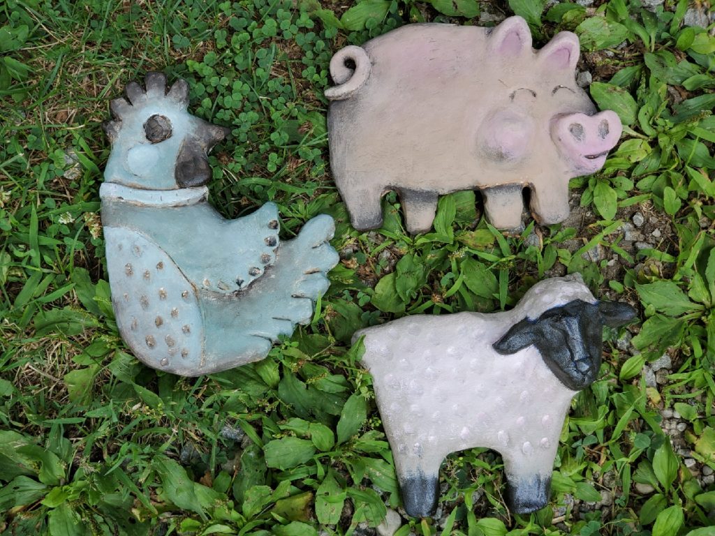 clay scuplture of chicken lamb and pig