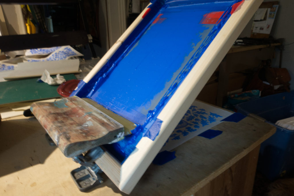 silkscreen loaded with blue ceramic underglaze