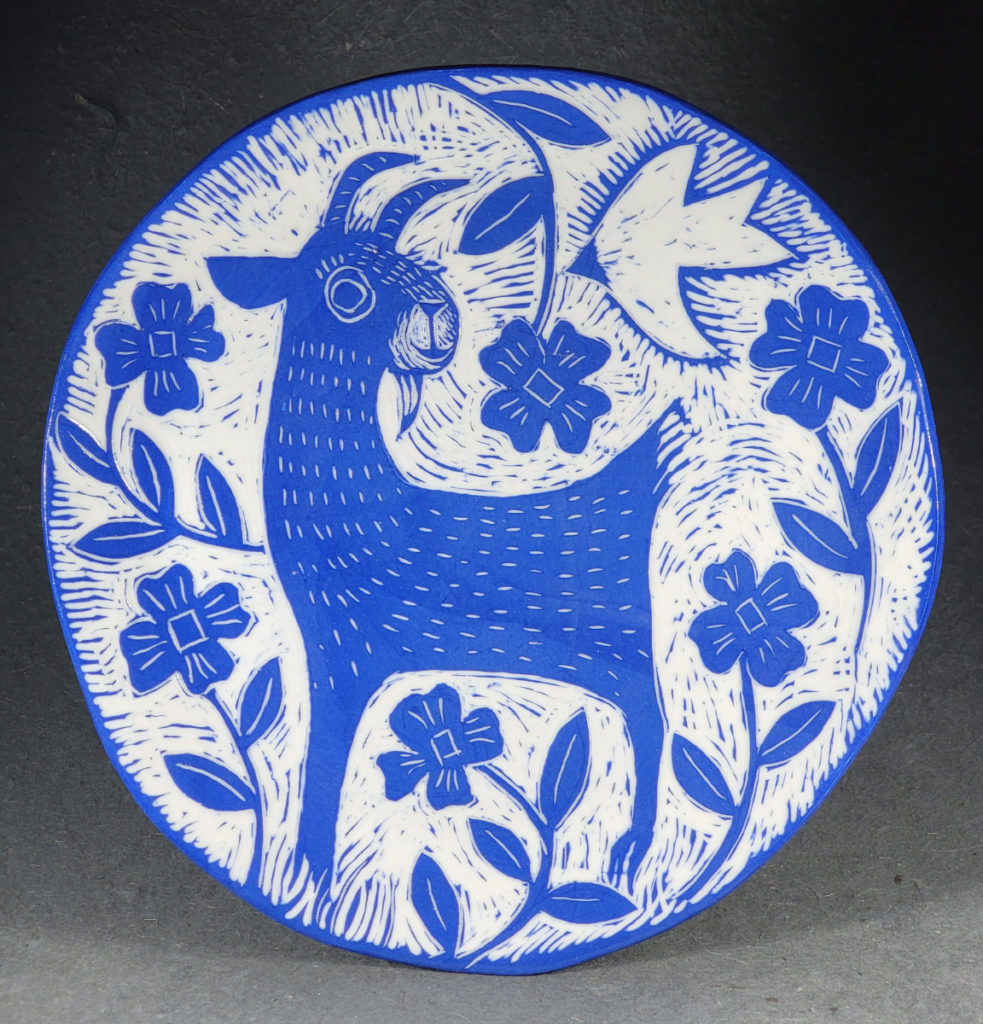blue porcelain plate with goat and flowers design