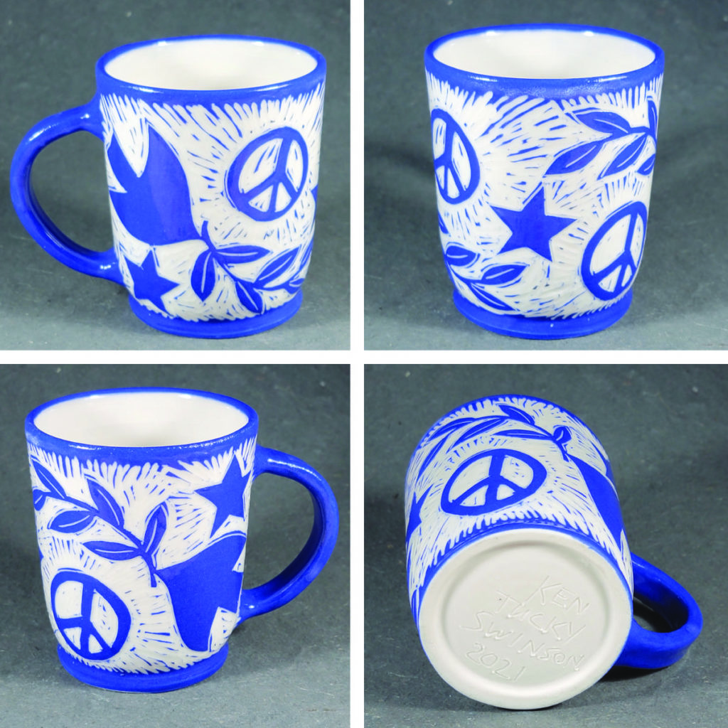 porcelain mug with blue design of birds carrying olive branch and peace symbol