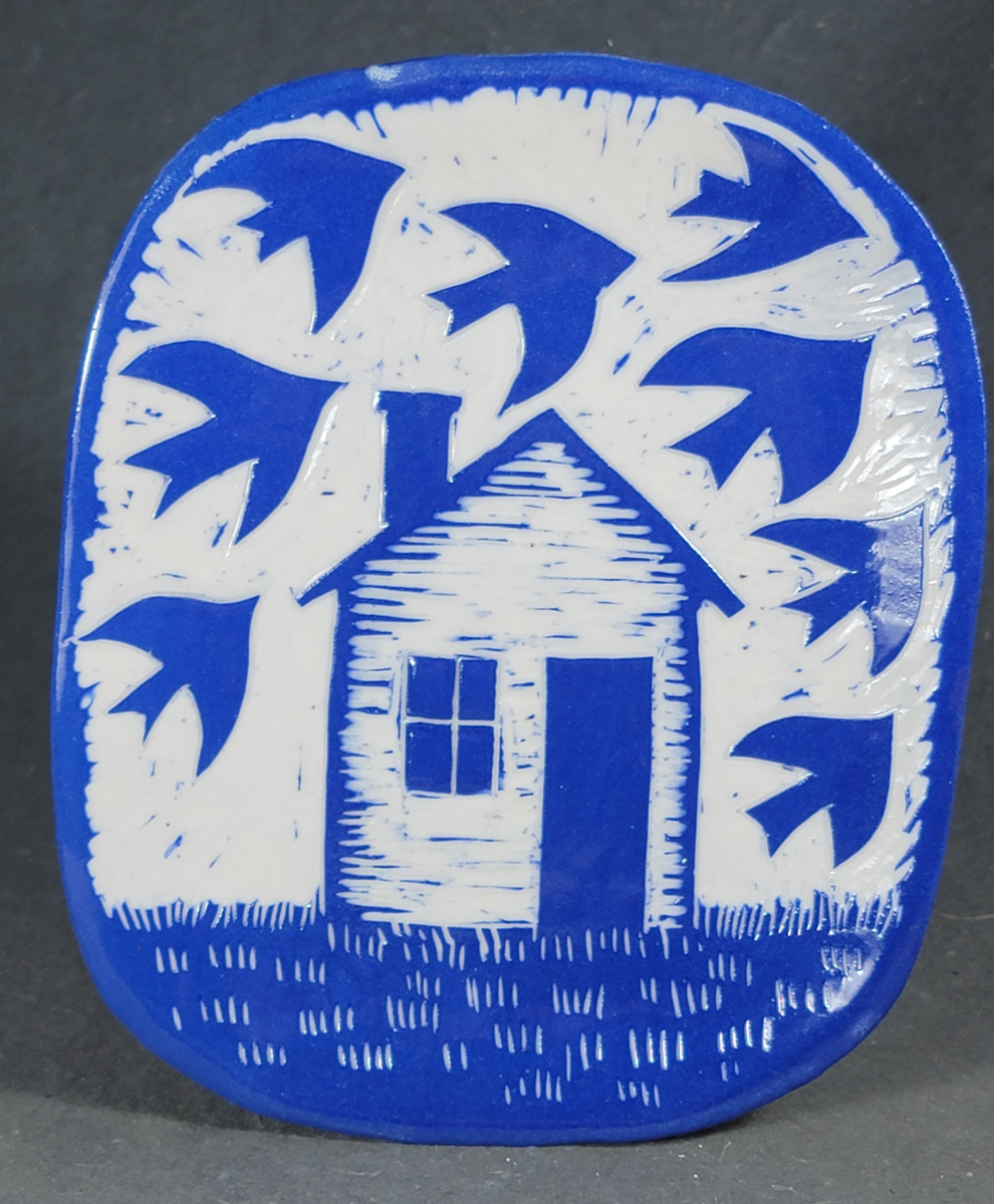 folk art style porcelain plate of house with birds