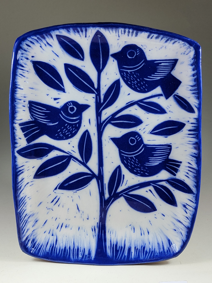 porcelain plate with blue birds in tree sgraffito design