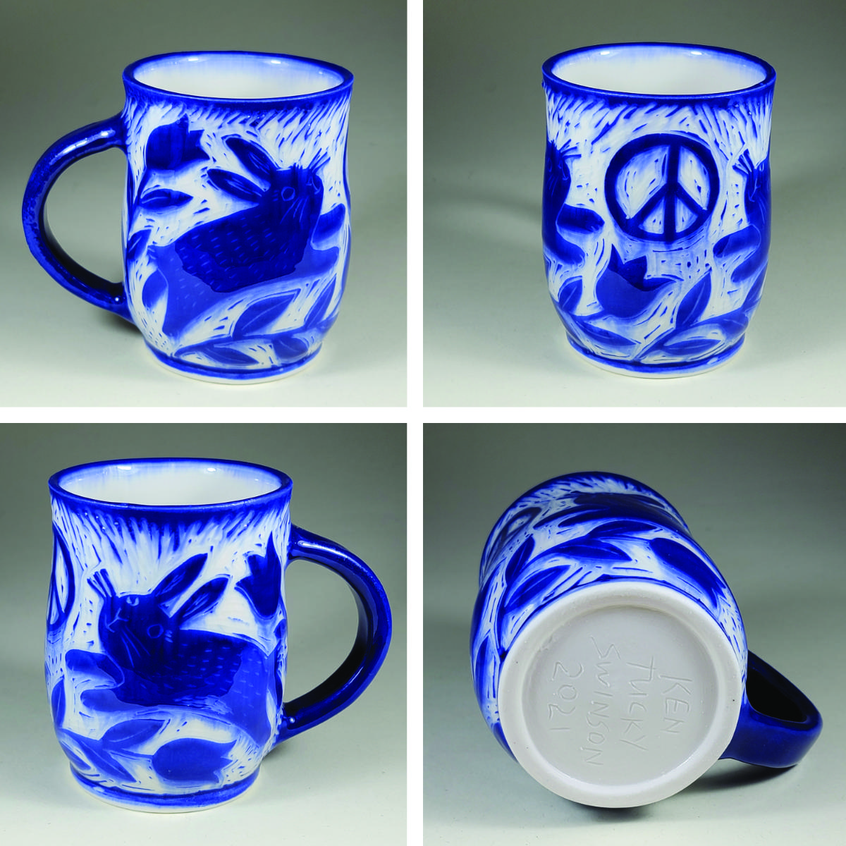 porcelain cup with blue bunny sgraffito decorations
