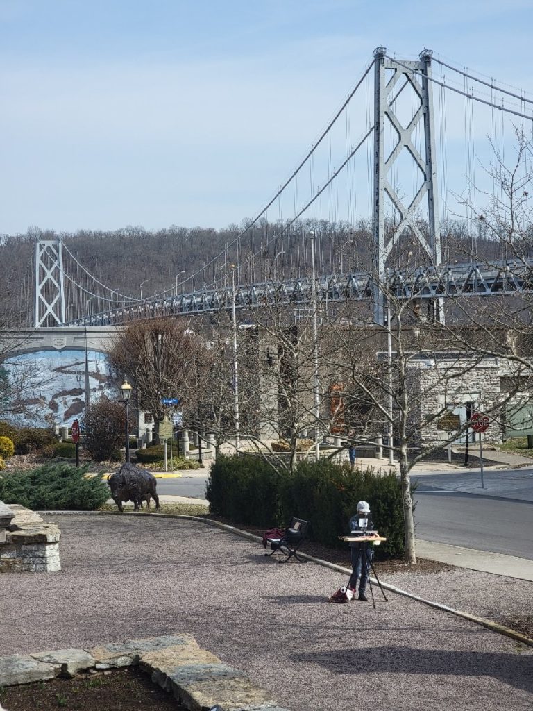 plein air artist working in downtown maysville ky near the bridge over the ohio river