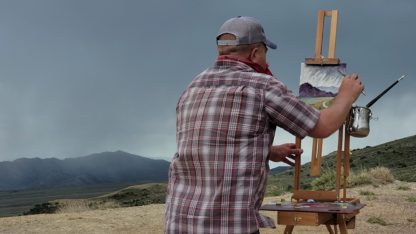 photo of ken Swinson painting outside in wyoming
