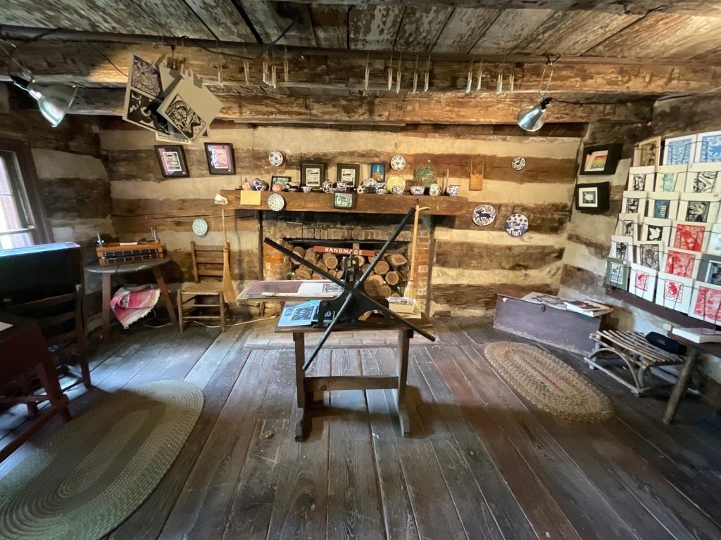 photo of the showroom and small etching press at the log cabin print shop