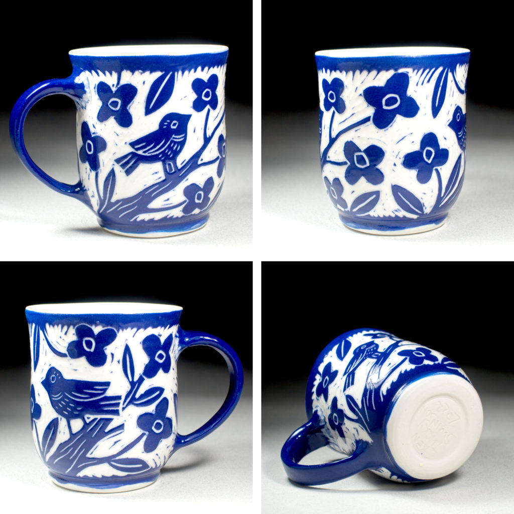 blue porcelain cup with bird and flowering tree design by kentucky artist ken swinson