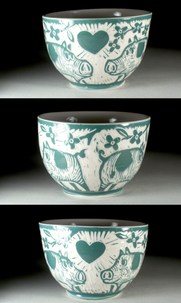 green bowl with design of two pigs in love by kentucky artist, ken swinson
