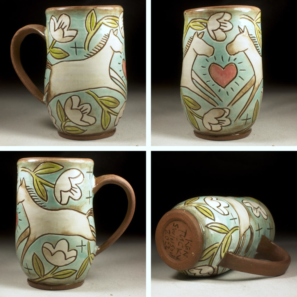 handmade stoneware cup decorated with two horses, flowers and a heart design