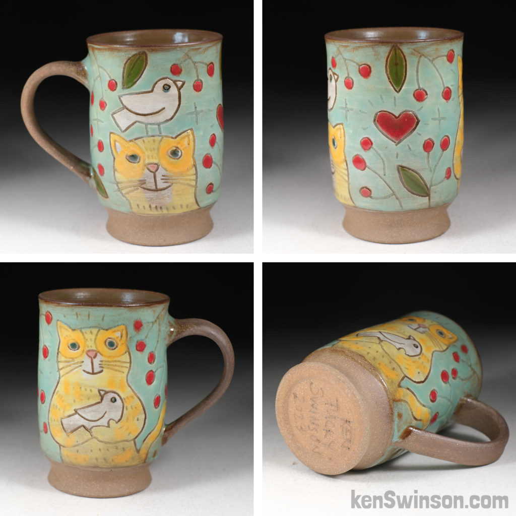 handmade stoneware cup with yellow cat and bird surface design