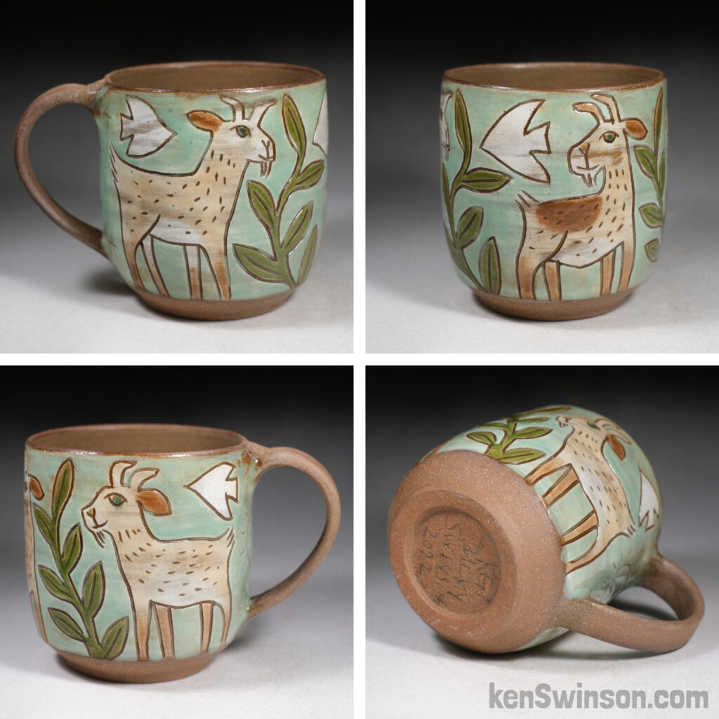 handmade cup with folk art style decoration of goats and plants
