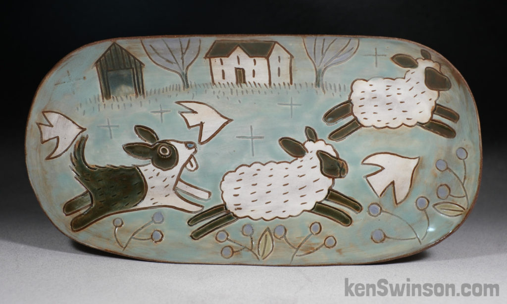 handmade stoneware oval plate with sheep dog chasing sheep surface design