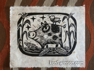 black and white linocut of a pig eating corn