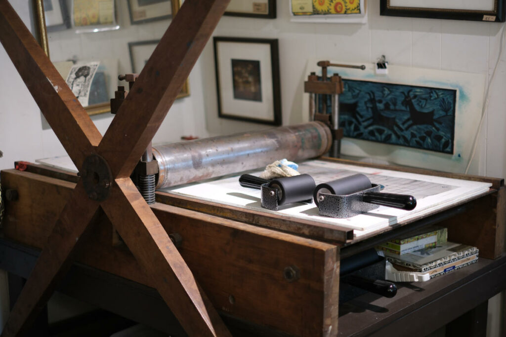 printmaking studio with handmade wood etching press