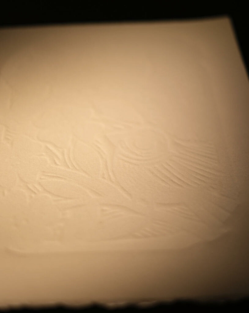 cotton paper with an embossing after going through the press