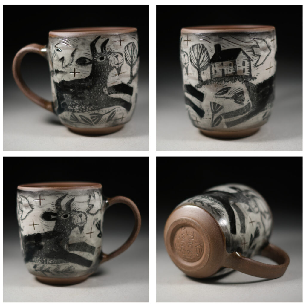 A red stoneware cup with white slip and a goat decal