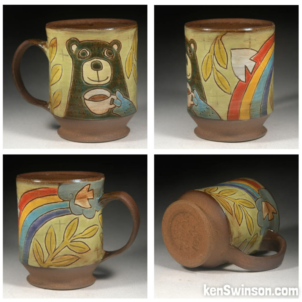 folk art pottery wheel thrown cup made in kentucky with a bear drinking from a cup sitting under a rainbow