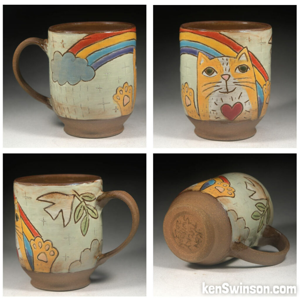folk art pottery wheel thrown cup made in kentucky with a yellow cat under a rainbow design