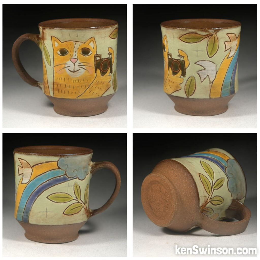 folk art pottery wheel thrown cup made in kentucky with a yellow cat taking photos of birds under a rainbow on the surface design
