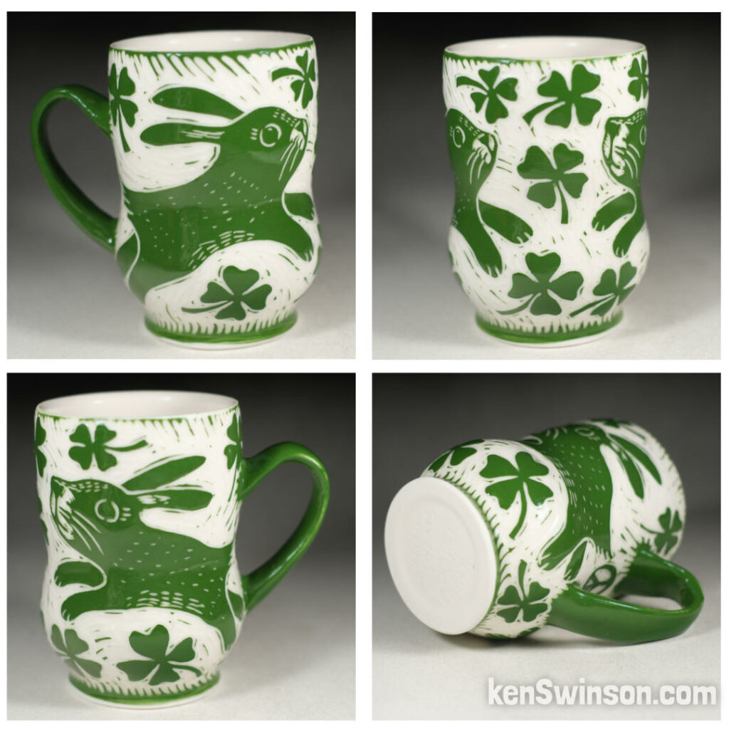 handmade porcelain cup by kentucky artist ken swinson. surface design is green with a rabbit and 4 leaf clovers